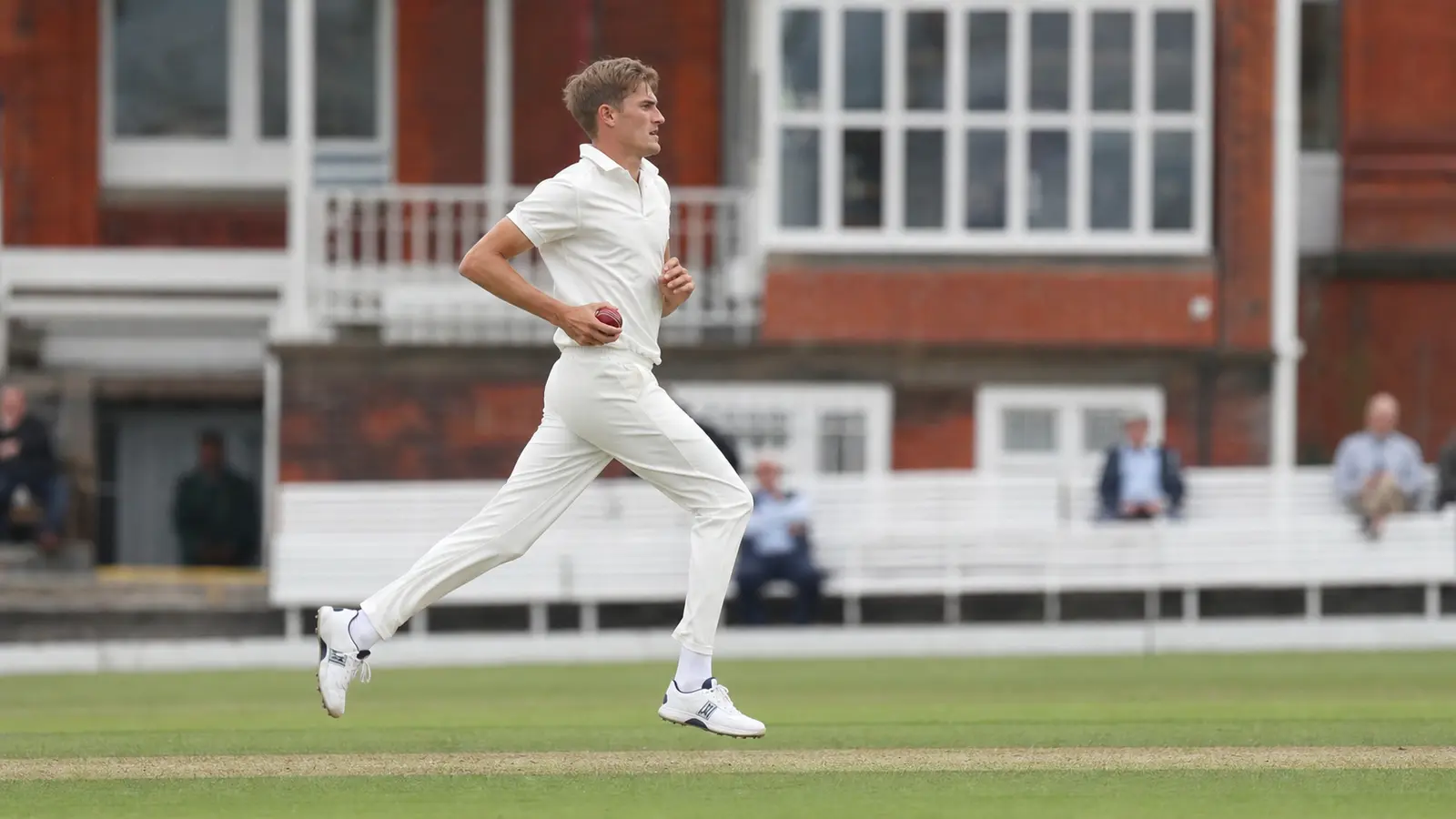 Seamer running in to bowl a long spell on a county ground